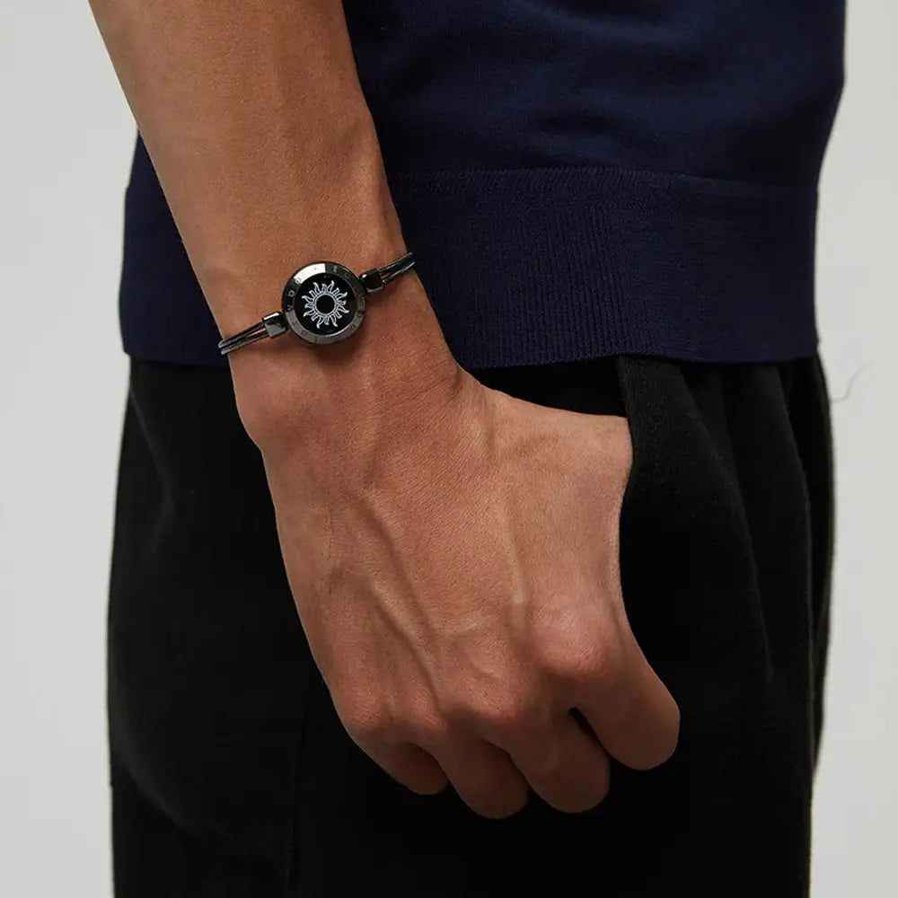 A man wearing the EntangleTies™ Sun bracelet with a rope cord design, hand in pocket, against a minimalistic background.