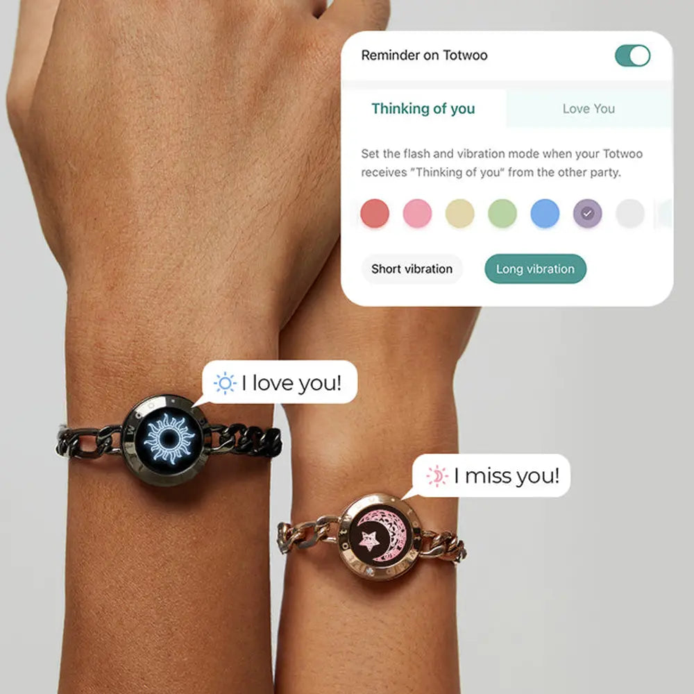 Two hands wearing EntangleTies™ bracelets, with a digital notification showing custom reminders on the Totwoo™ app. One bracelet, featuring a black Sun charm, displays ‘I love you!’ with a blue light, while the other, with a gold Moon charm, displays ‘I miss you!’ with a pink light. The Totwoo™ app interface allows users to set flash and vibration reminders, enhancing connection between couples.