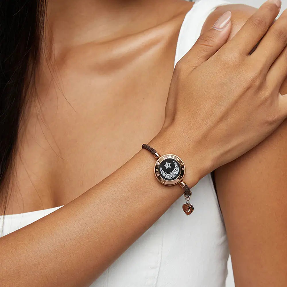 A woman wearing the EntangleTies™ Moon bracelet with a charm attached, complementing her outfit and minimalistic style.